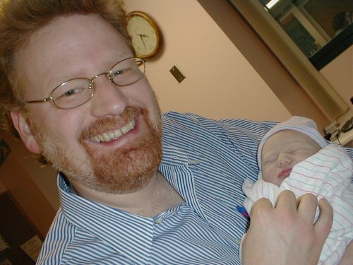 Daddy holding me and beaming